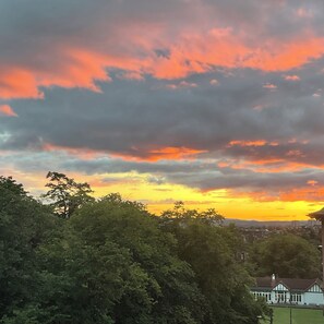 A sunset with clouds over a residential area.
