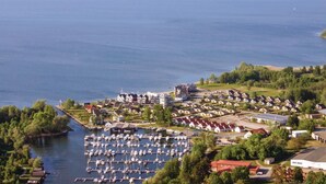 An aerial view of a lakeside residential area with a marina filled with boats. - Stunning home in Rechlin with sauna (Rechlin)