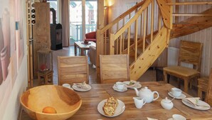 A cozy dining area with wooden furniture, a large wooden bowl, and a staircase. - Nice apartment in Rechlin with WiFi (Rechlin)