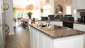 A modern kitchen with white cabinetry, granite countertops, and stainless steel appliances. - Close to BROADWAY BNA-Gorgeous Home - Idyllic Countryside, Heated Pool & Hot Tub (Mt Juliet)