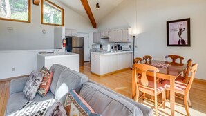 A modern kitchen with a central island, wooden dining table, and chairs. - Lake & Mountain Views Condo - 5 min. drive to lake, ski and golf (Incline Village)