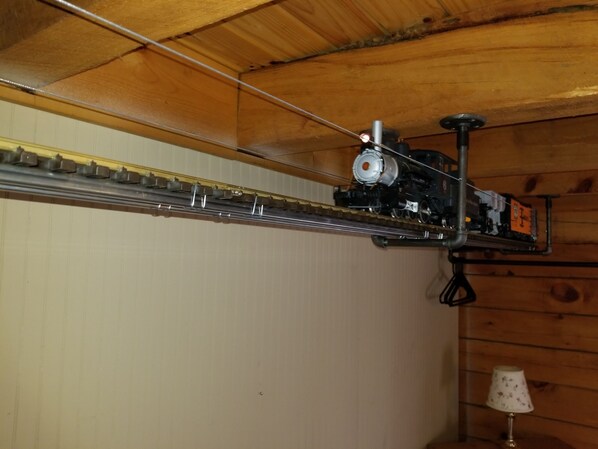 A model train set on a track in a wooden room.
