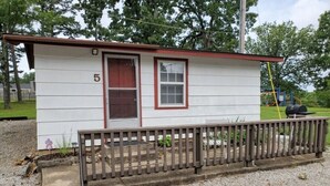 A small, single-story building with a number '5' on its side, a door, and a window. - Rustic Charm Cabin for Families, Couples, or Fishing, Hunting  ON Norfork Lake!  (Gamaliel)