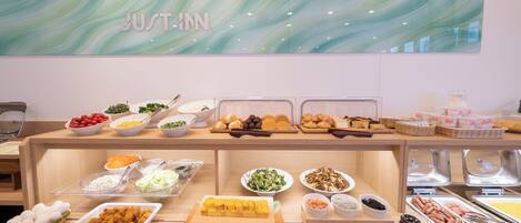 Un mostrador de buffet con diferentes alimentos y un letrero que dice 'RECIÉN ARRIVADO'.