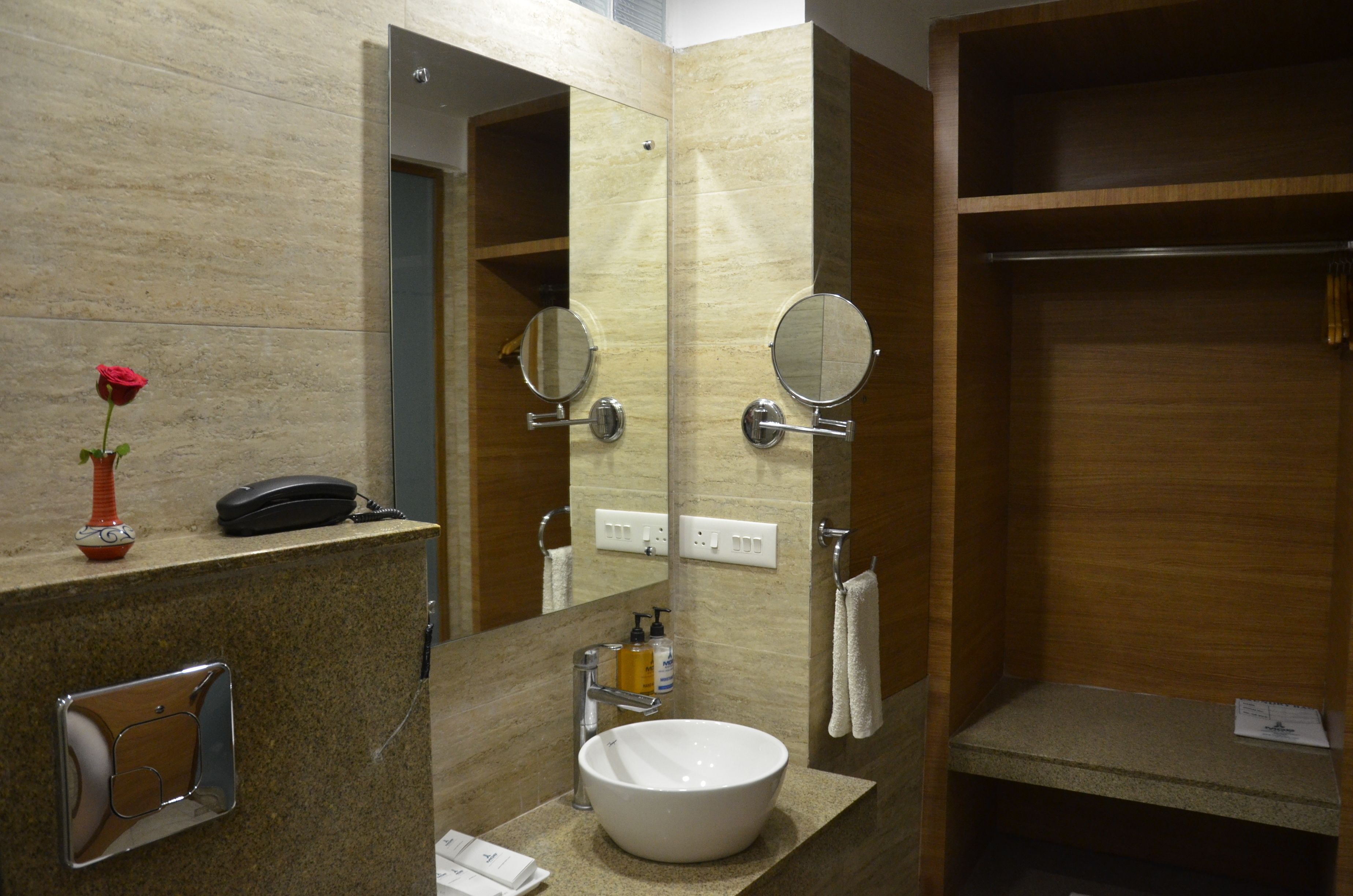 A modern bathroom with a large mirror, a sink, and a vanity.