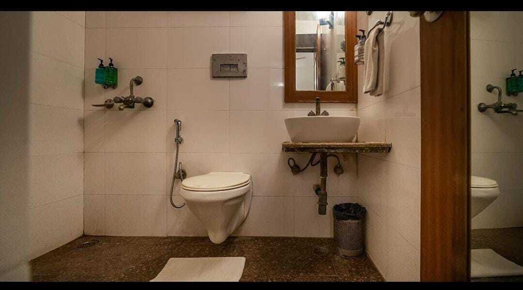 A bathroom with a toilet, sink, and shower.