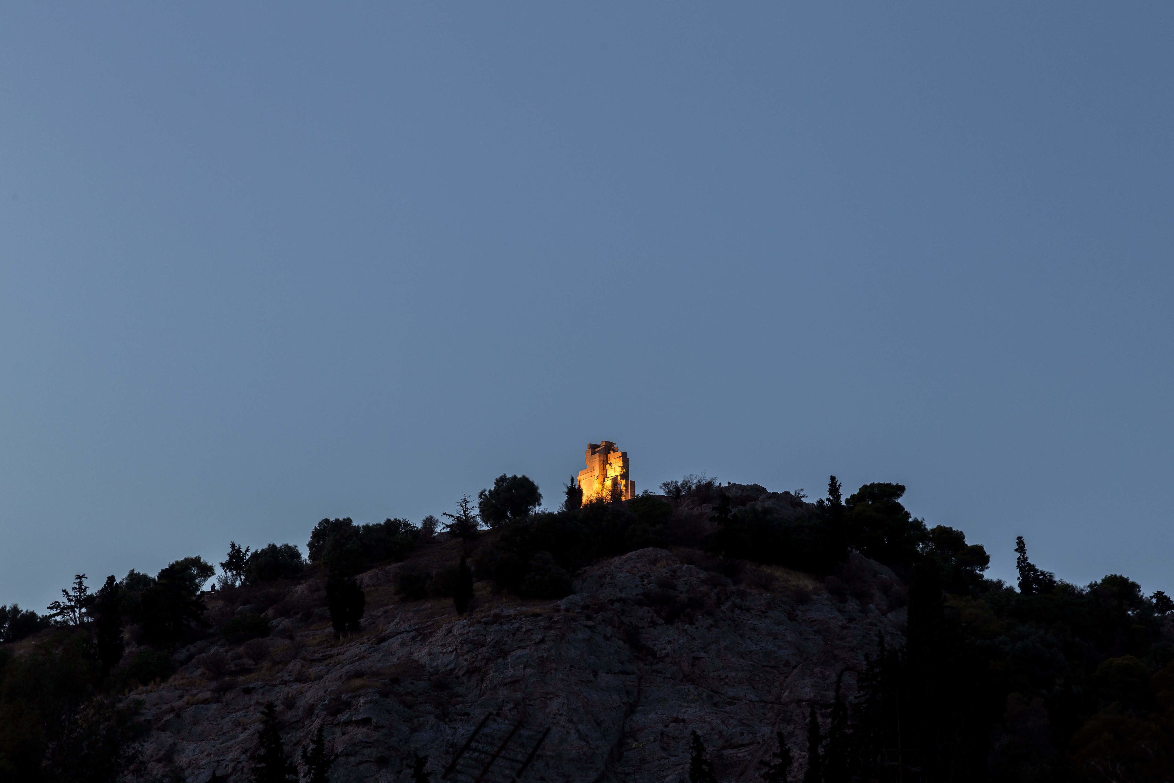 A building on a hill with a clear sky.