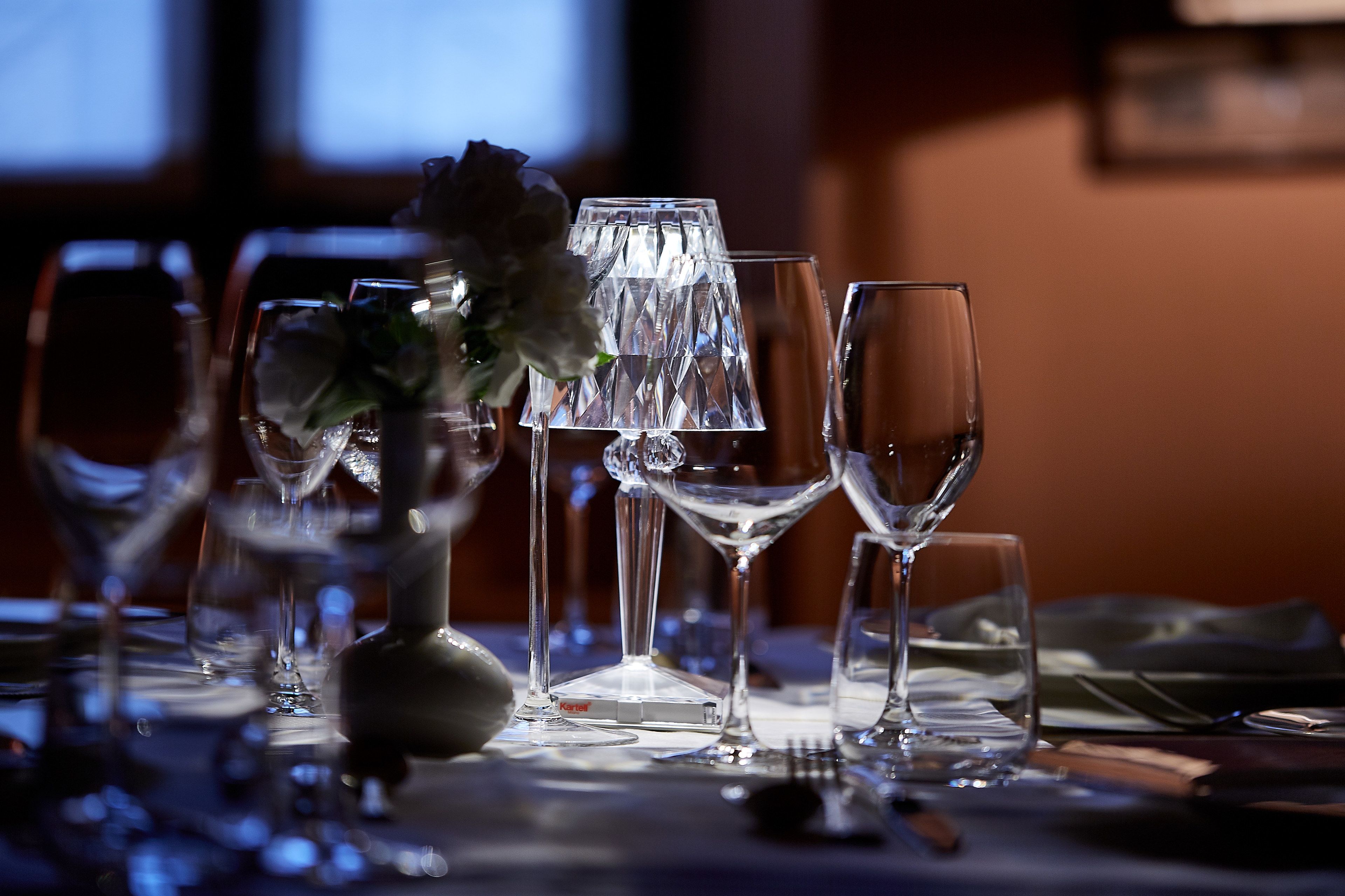 Una mesa dispuesta con diferentes vasos y un florero con flores.
