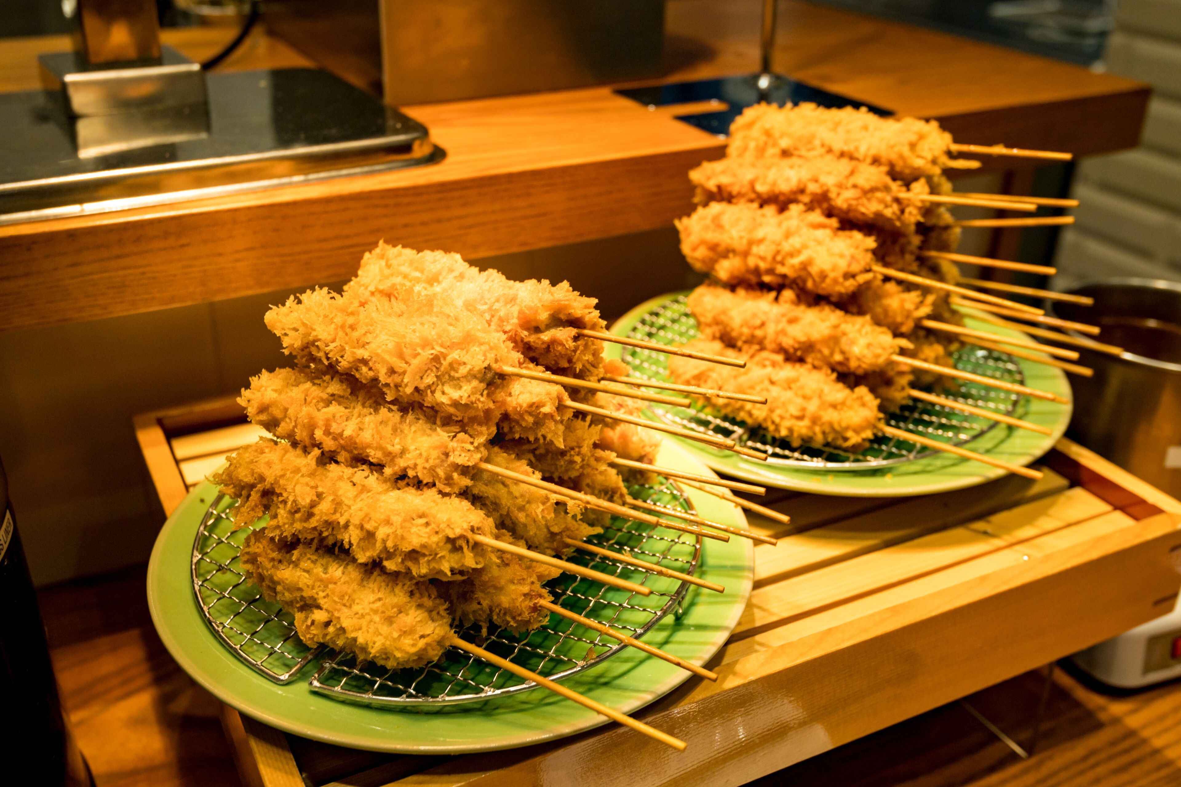 A buffet table with skewers of fried food.