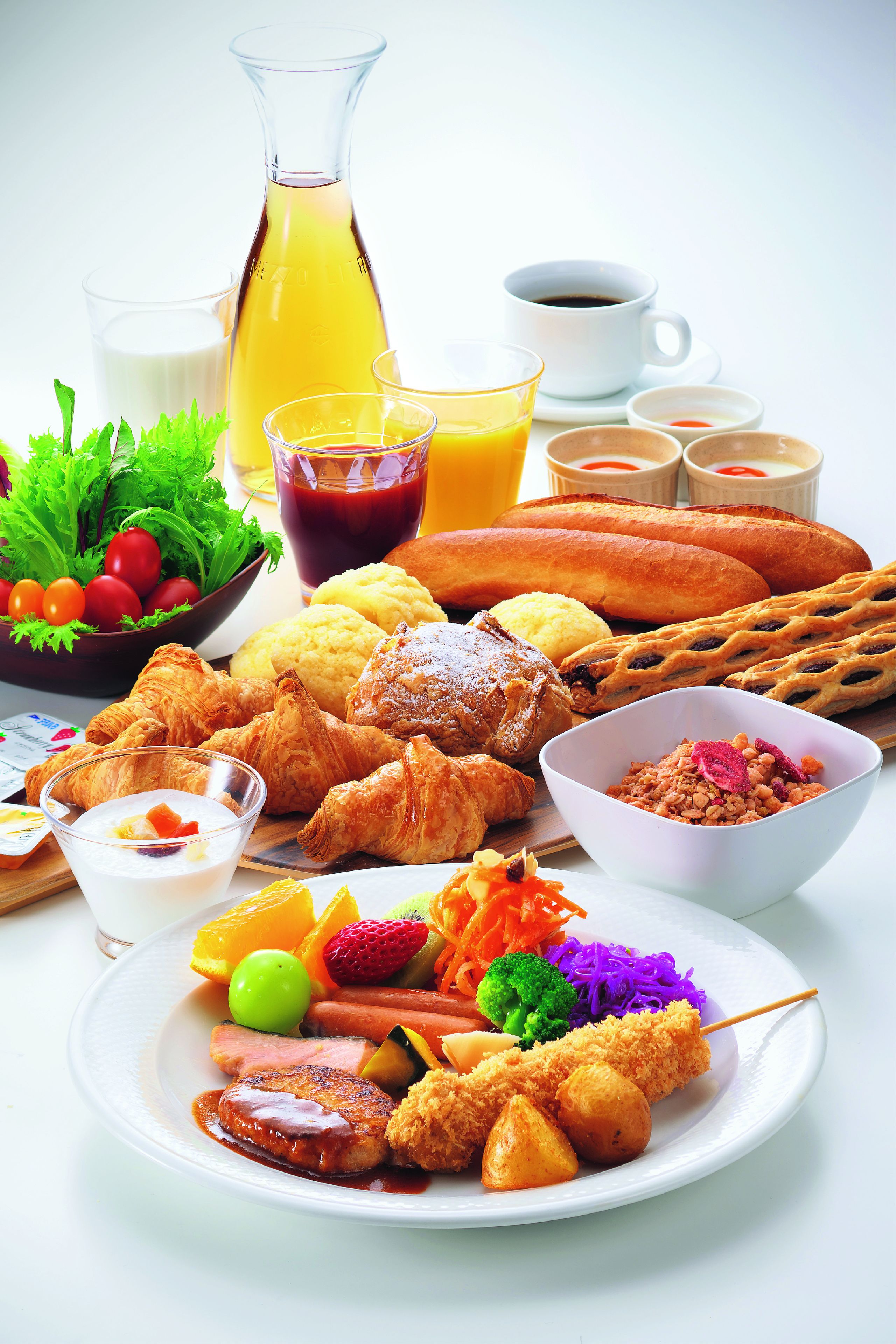 A breakfast spread with various foods and drinks.