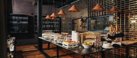 A buffet setup with various food items and a wine rack in a modern kitchen setting.