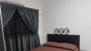 A bedroom with a bed, a nightstand, and a wall-mounted shelf with decorative items. - Araaz Homestay (Seremban)