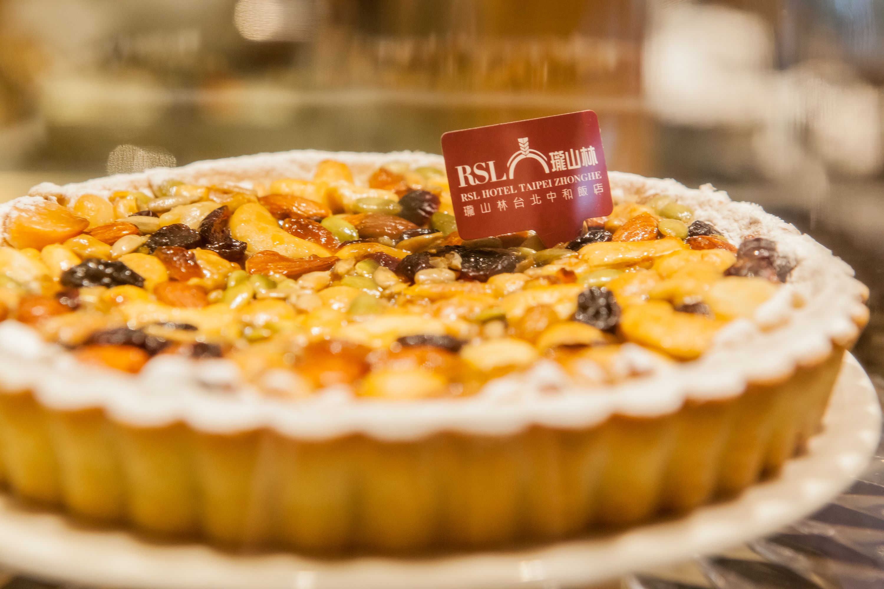 A dessert with a variety of fruits and nuts on a plate.