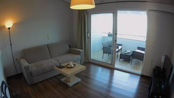 Apartment, 1 Bedroom, Sea View | Living room | TV