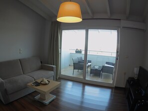 Apartment, 1 Bedroom, Sea View | Living area | TV