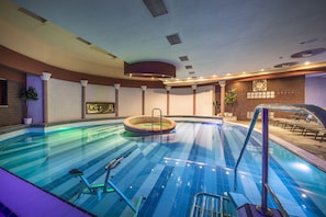 An indoor swimming pool with a hot tub, exercise equipment, and a clock on the wall. - Therma Nea Dunajská Streda (Dunajska Streda)