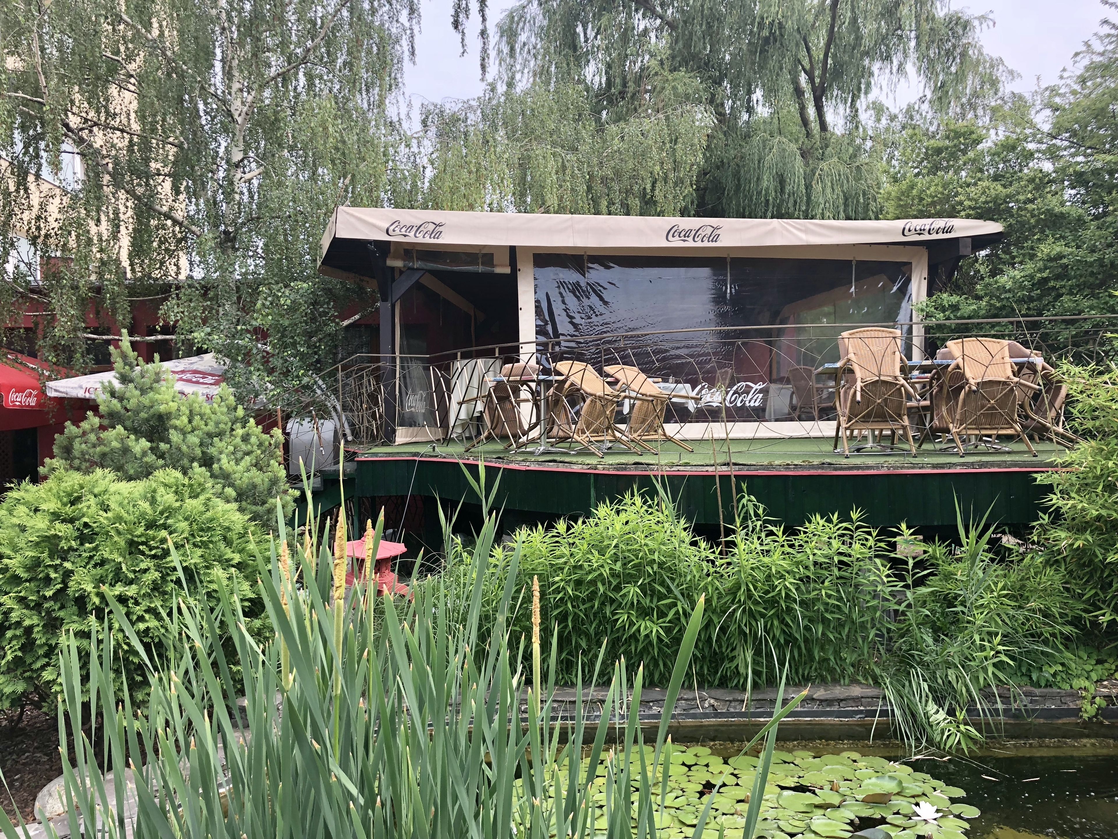 A floating restaurant with outdoor seating and Coca-Cola branding.