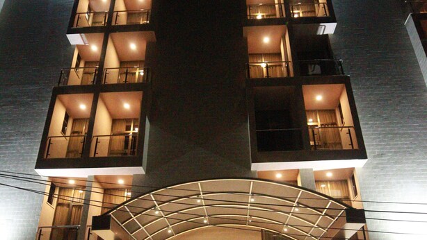 A multi-story building with a central entrance, multiple balconies, and a staircase leading to the entrance. - Marcen Addis Hotel (Addis Ababa)