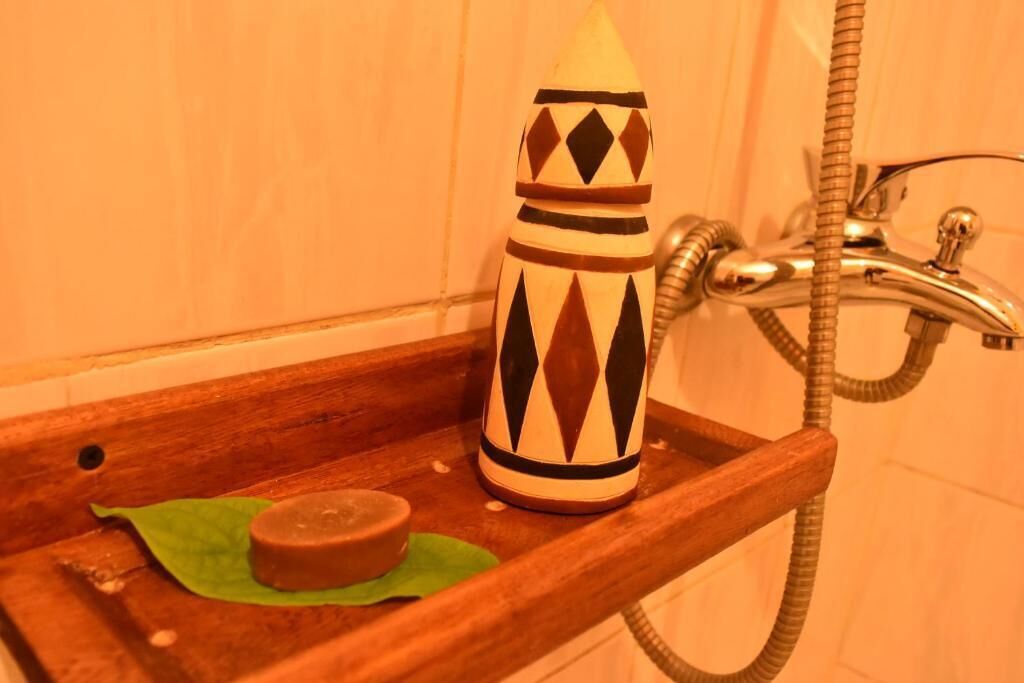A bathroom with a shower, a soap dish, and a decorative soap holder.