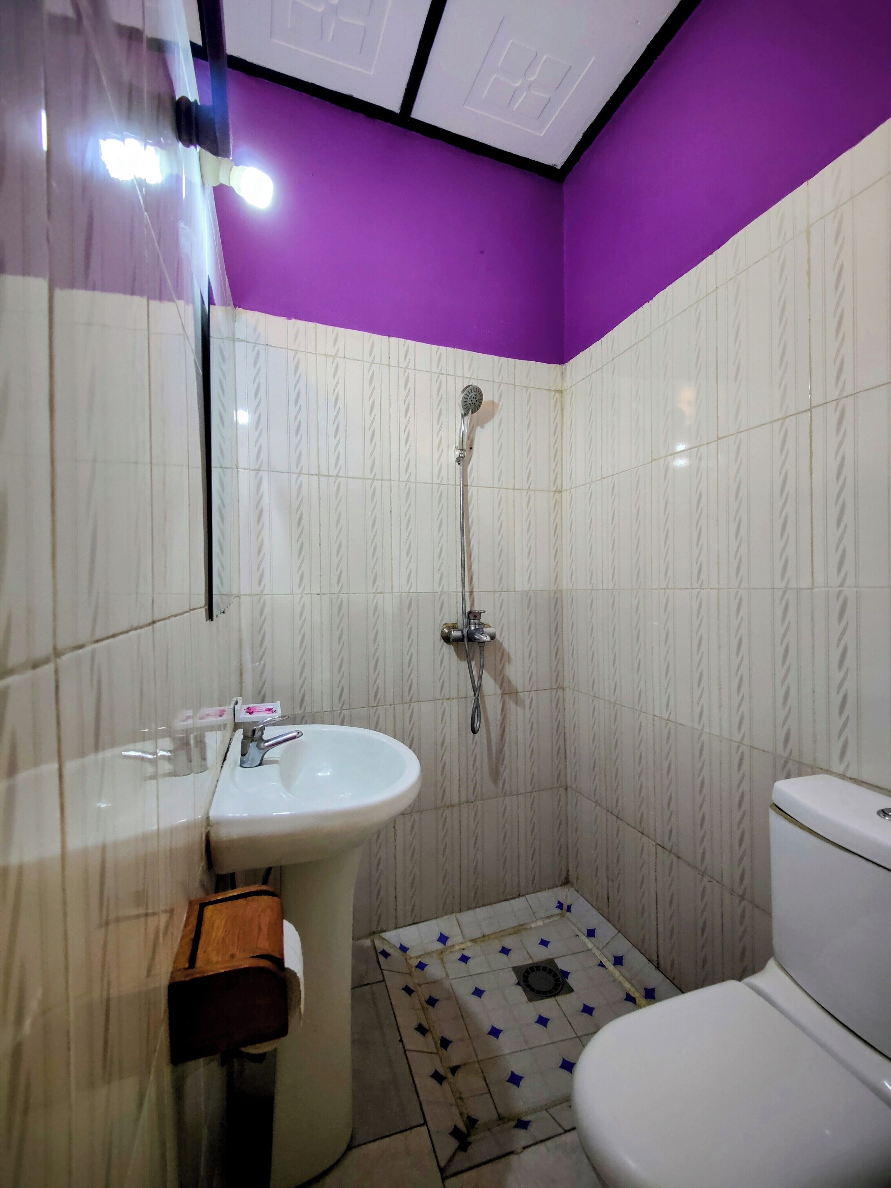 A bathroom with a sink, toilet, and shower.
