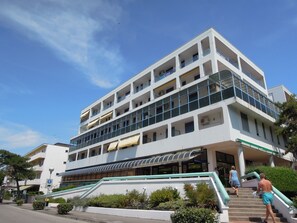 A multi-story hotel with a modern design, featuring balconies on each floor and a covered entrance area. - Appartamenti Tonin (San Michele al Tagliamento)