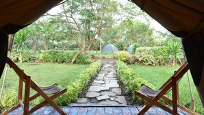 A tented area with a stone pathway leading to a garden. - Red Rocks Campsite & Guesthouse (Muko)