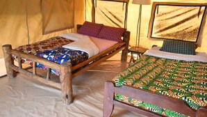 A tent with two beds, each with a wooden frame and patterned bedding. - Red Rocks Campsite & Guesthouse (Muko)