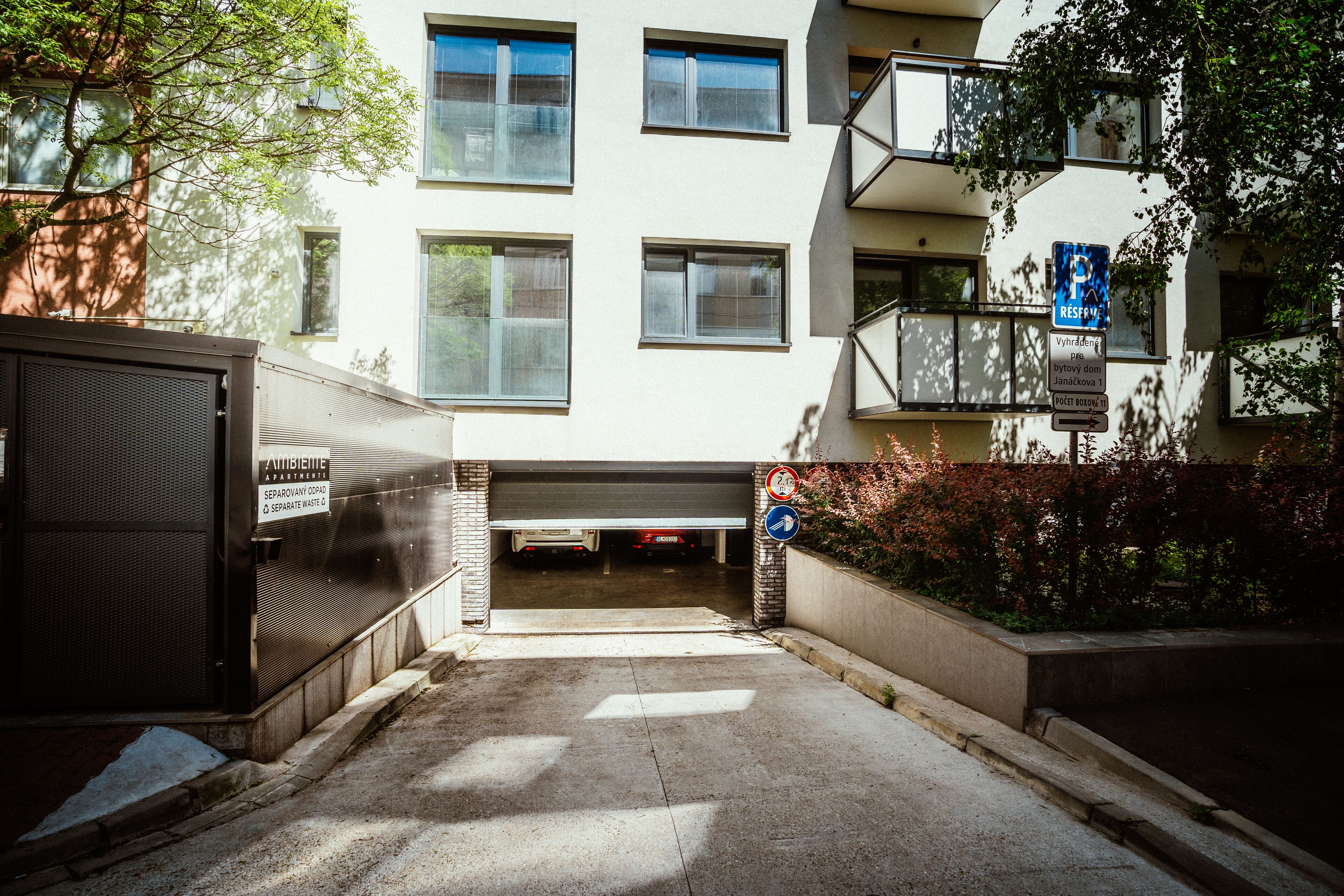 A parking garage entrance with a sign indicating reserved parking.