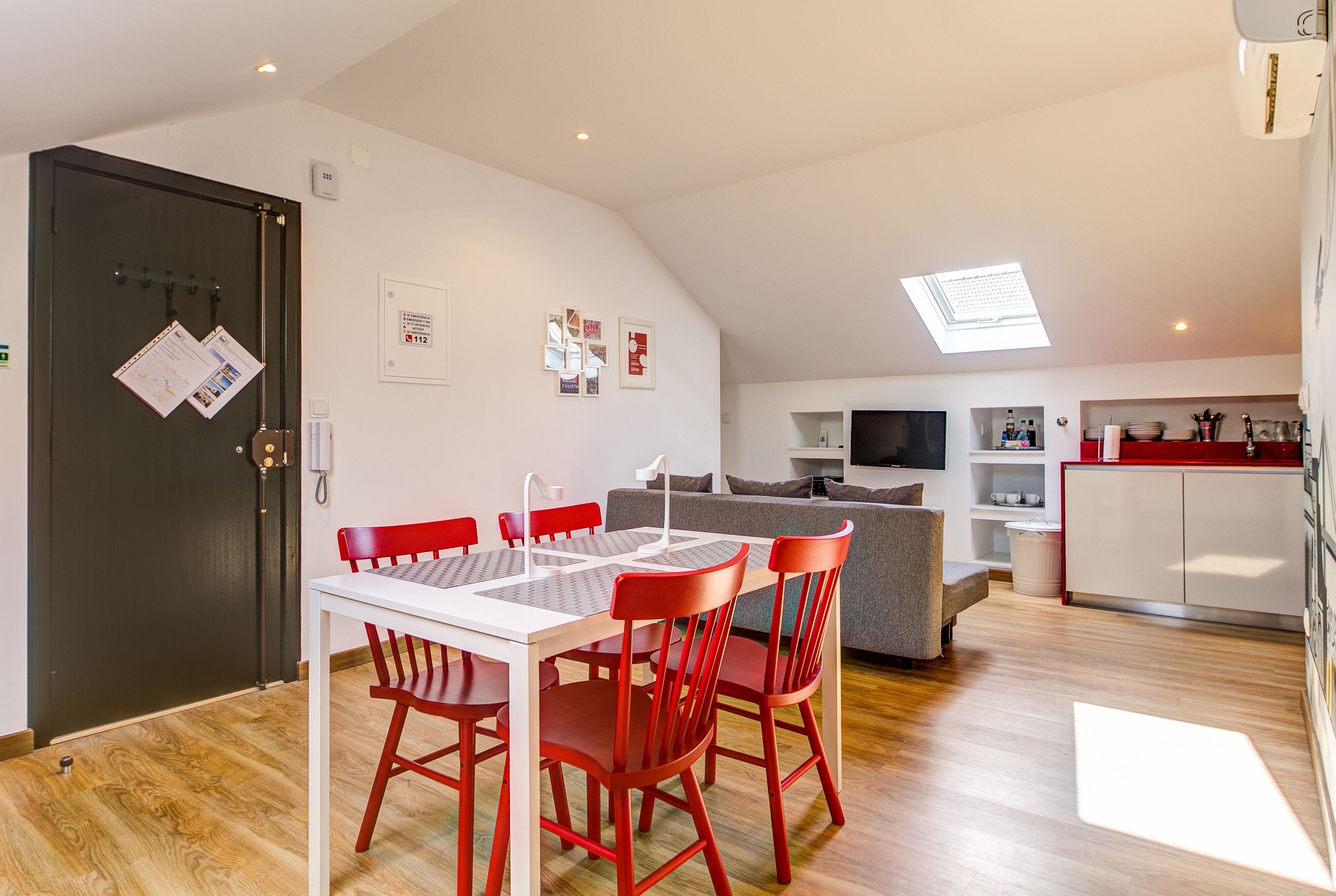 A modern apartment with a dining area, kitchen, and living space.