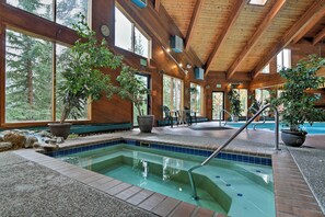 Relax by the pool surrounded by lush greenery and natural light.