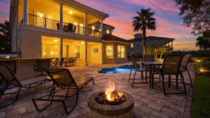 A two-story house with a pool, outdoor seating, and a fire pit. - Reunion Views | Movie Room, Amazing Views of the Tom Watson Golf Course (Kissimmee)