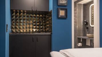 A modern bathroom with a shower, a toilet, and a sink.