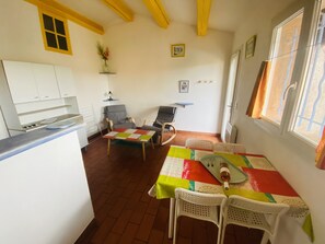 A compact living space with a kitchen, dining area, and seating.