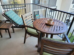 Enjoy a quiet moment on the balcony with a round table and two comfortable chairs.