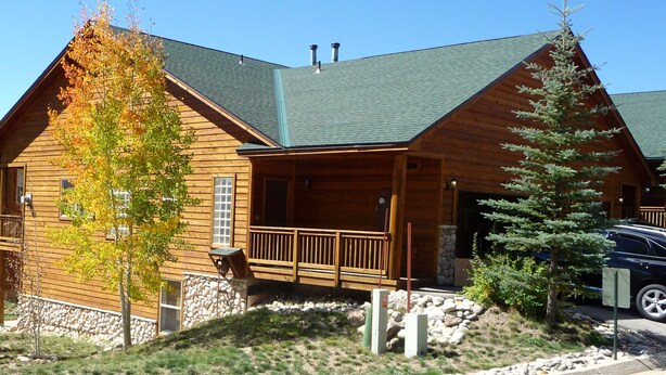 A log cabin with a porch, stone foundation, and a car parked in front. - Family Friendly 3 Bedroom, 3 Bath, Mt. Home, Close To 6 World Famous Ski Areas (Dillon)