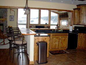 The open concept kitchen features granite countertops and handcrafted cabinet.