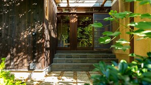 A traditional Japanese-style entrance with a wooden door and stone steps leading to a covered porch. - Kazeno Naramachi (Nara)