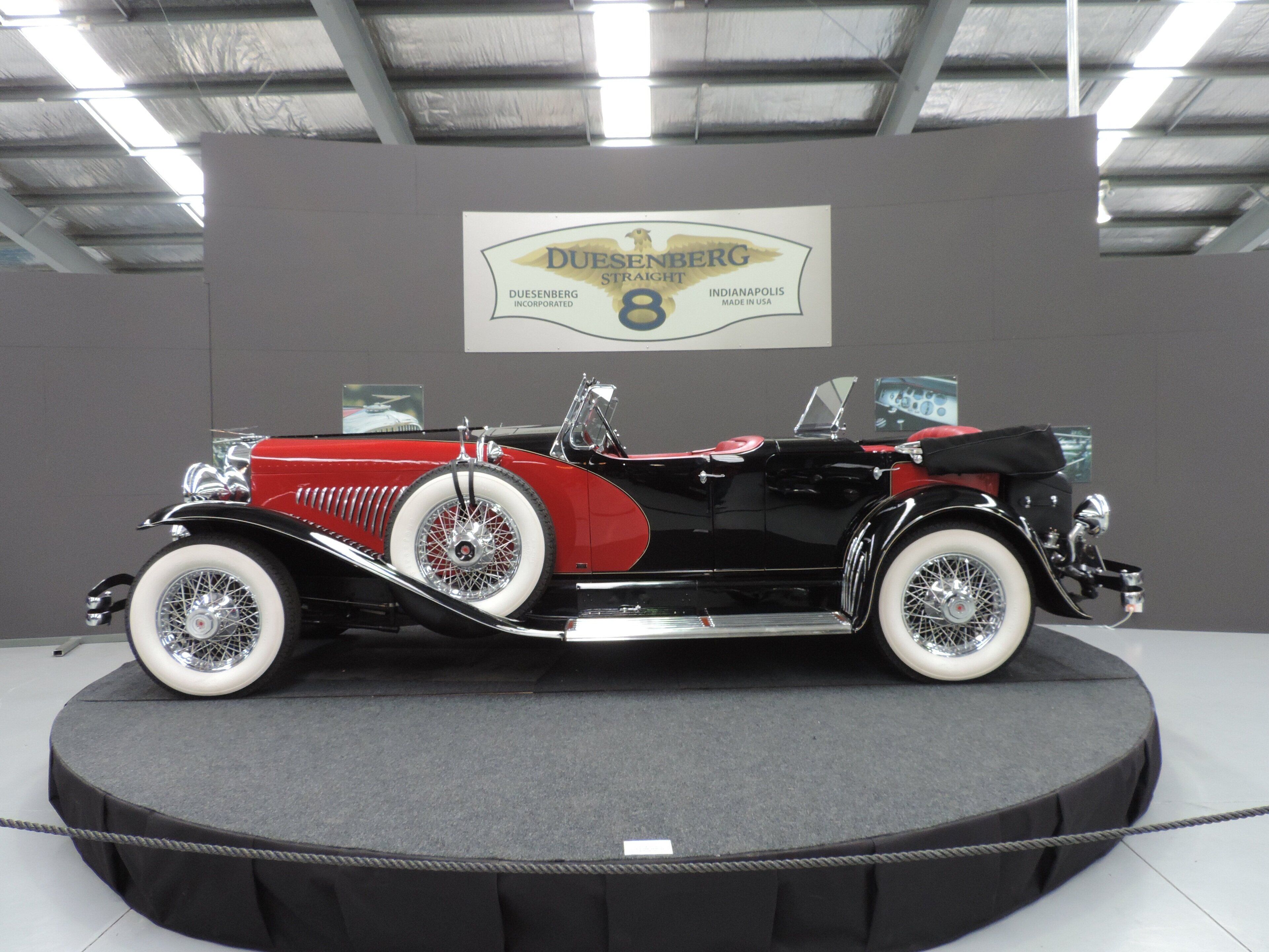 A vintage car on display in a museum.