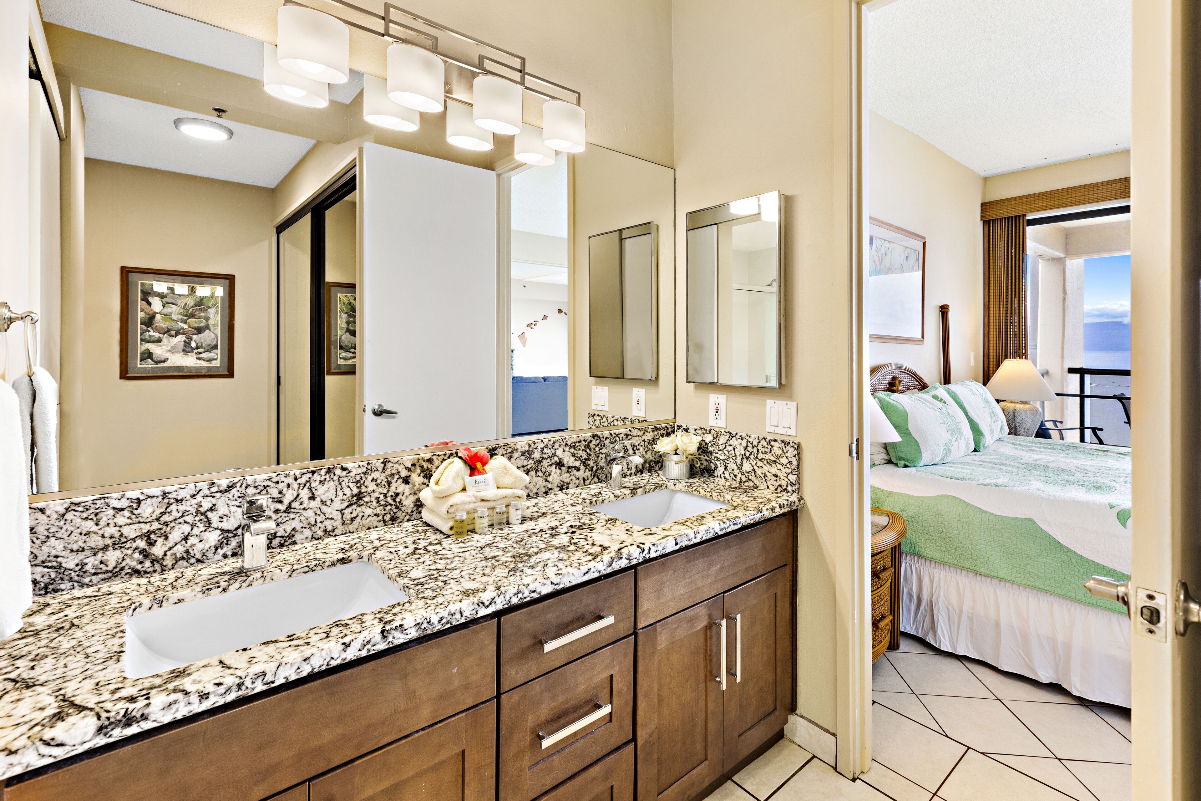 A bathroom with a double sink, a large mirror, and a vanity with drawers.