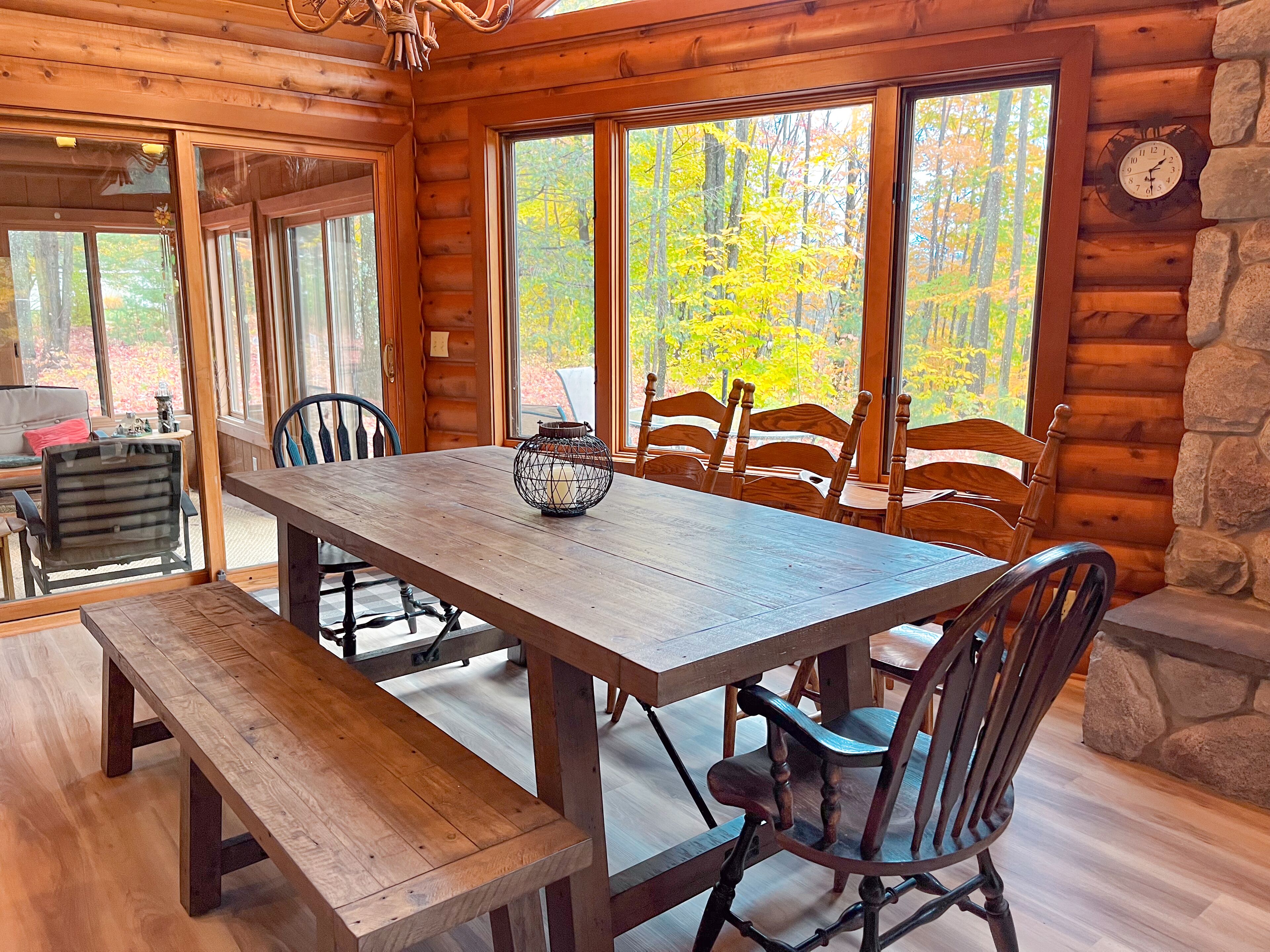 A wooden dining table with chairs, a bench, and a decorative lantern.