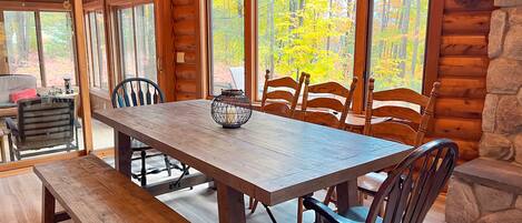 A wooden dining table with chairs, a bench, and a decorative lantern.