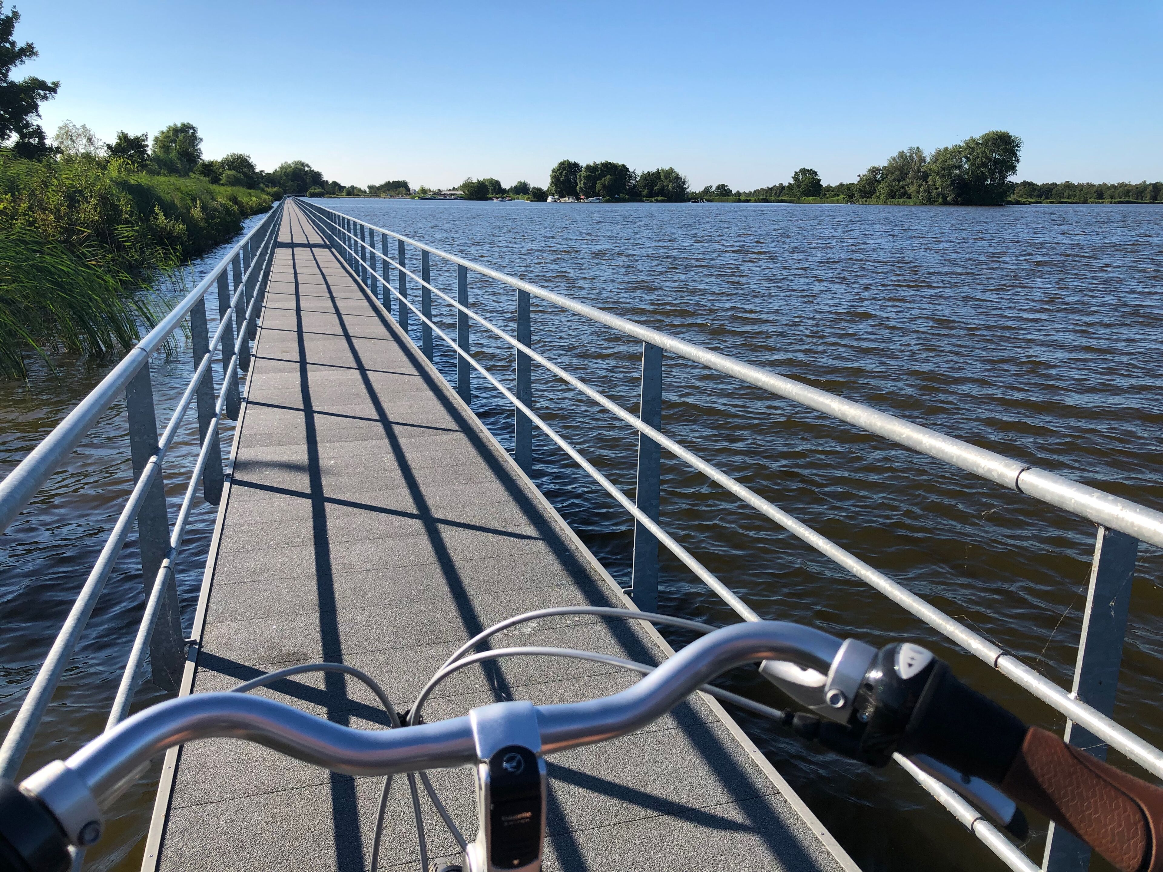 A bridge with metal railings and a bicycle path.
