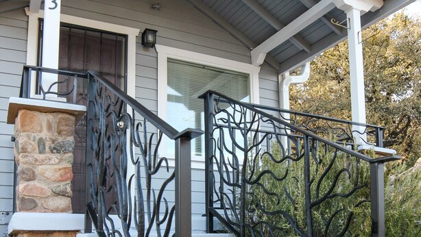 A house with a stone staircase, a metal railing, and a flower pot. - Sam Hill's Cottage In historic Prescott Arizona (Prescott)