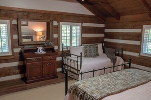 Cozy bedroom with a single bed, wooden dresser, and mirror.