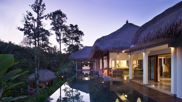 A modern resort with thatched-roof villas, a reflective pool, and lush tropical vegetation. - Elegant, Intimate, Luxury Contemporary Balinese Villa  In a Traditional Village  (Kemenuh, Sukawati,)