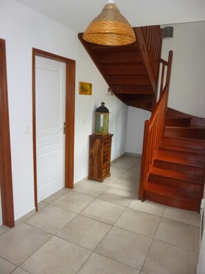 Staircase leads to an upper level with a wooden handrail and steps.