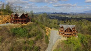 A large wooden cabin with multiple balconies and a scenic mountain view. - Majestic Mountaintop Retreat- Breathtaking Views, Luxury Lodge over Pigeon Forge (Sevierville)