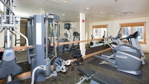 A gym with various exercise equipment, including a treadmill, weight machines, and a mirror. - Mountain Condo for 4 | Hot Tub + Pool Access (Dillon)