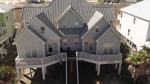 A beachfront property with a central building featuring a staircase leading to a balcony, surrounded by other buildings. - Spectacular Gulf Views in Gated Community with Pool and Hot Tub. Quite beach!   (Gulf Shores)