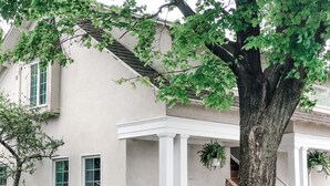 A house with a porch, a white bench, and a staircase leading to the entrance. - Botanical Loft in Amish Country, King Bed, Jetted Tub & Garden Patio (Bird-In-Hand)